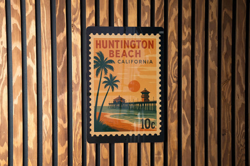A postage stamp depicting Huntington Beach, California, with a beach scene and palm trees.