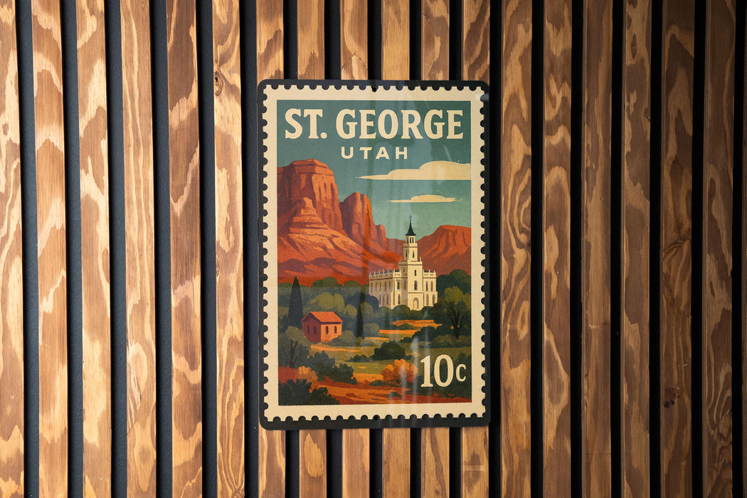 A postage stamp from St. George, Utah, featuring a scenic landscape with mountains, buildings, and a church.