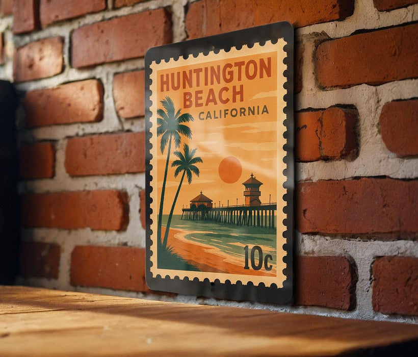 A vintage-style postage stamp depicting a beach scene with palm trees, a pier, and a sunset, mounted on a brick wall.