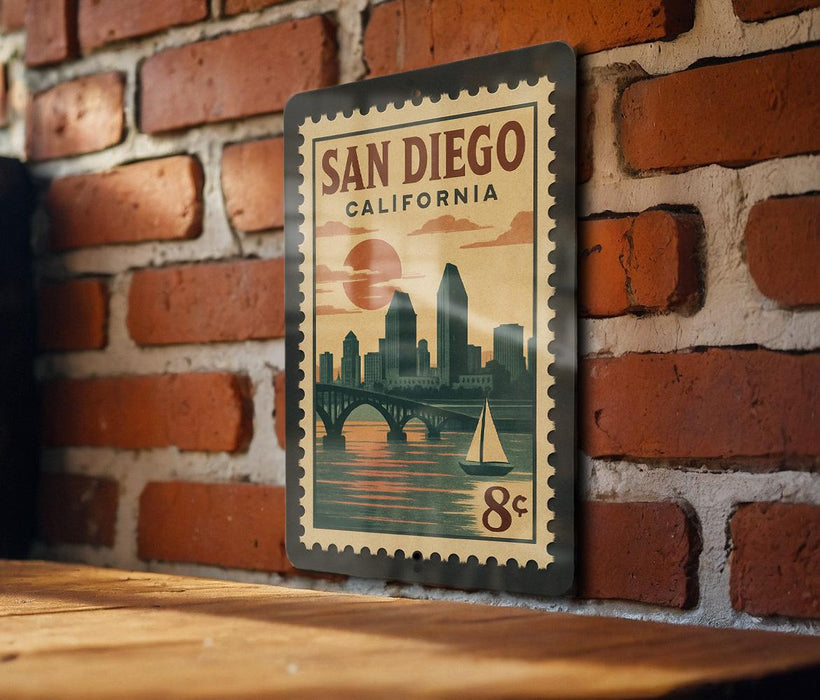 A vintage-style postage stamp featuring San Diego, California, with a cityscape and a sailboat on the water.