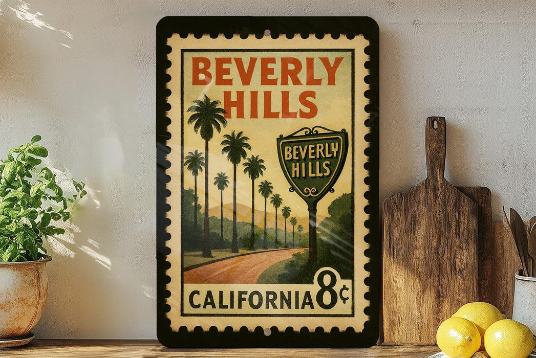 A framed vintage-style poster of Beverly Hills, California, featuring palm trees and a road, is displayed on a shelf next to a wooden cutting board and some lemons.