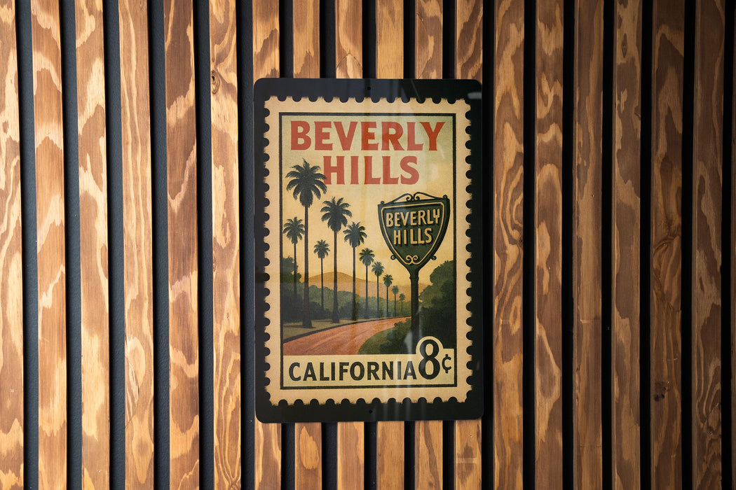 A vintage postage stamp featuring a scenic road and palm trees, with the text "Beverly Hills" and "California 8¢" printed on it.