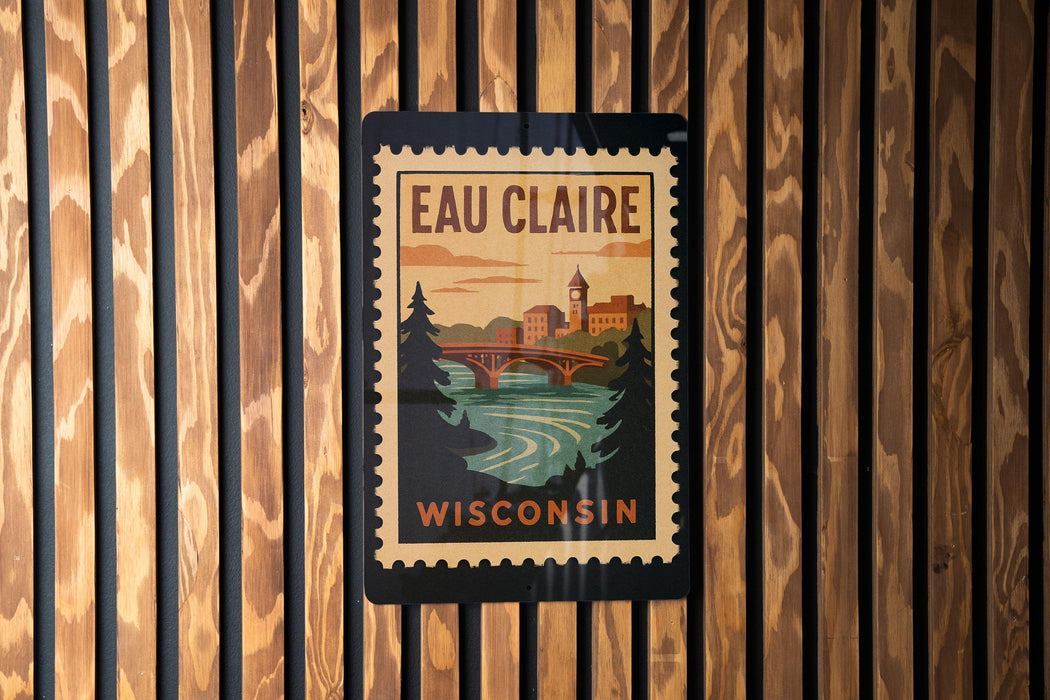A vintage-style poster of Eau Claire, Wisconsin, featuring a bridge and a river, is displayed on a wooden wall.