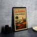 A framed poster of La Habra, California, featuring a scenic illustration of the town and its surroundings.
