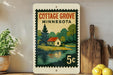 A vintage-style postage stamp depicting a cottage in Minnesota, with a lake and trees in the background.
