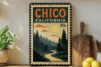 A vintage-style poster of Chico, California, featuring a scenic landscape with pine trees, a winding road, and a sun in the sky.