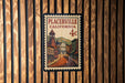 A vintage postage stamp from Placerville, California, featuring a street scene with buildings and a bell tower.
