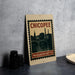 A framed poster of the city of Chicopee, Massachusetts, featuring a silhouette of the cityscape and a bridge.