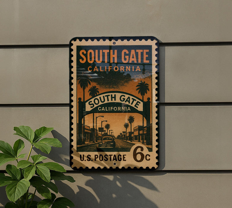 A vintage postage stamp from South Gate, California, featuring a street scene with palm trees and buildings.