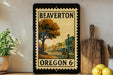 A framed vintage-style stamp depicting a street scene in Beaverton, Oregon, with a tree and buildings in the background.