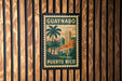 A vintage-style postage stamp from Puerto Rico featuring a tropical cityscape with palm trees and buildings.