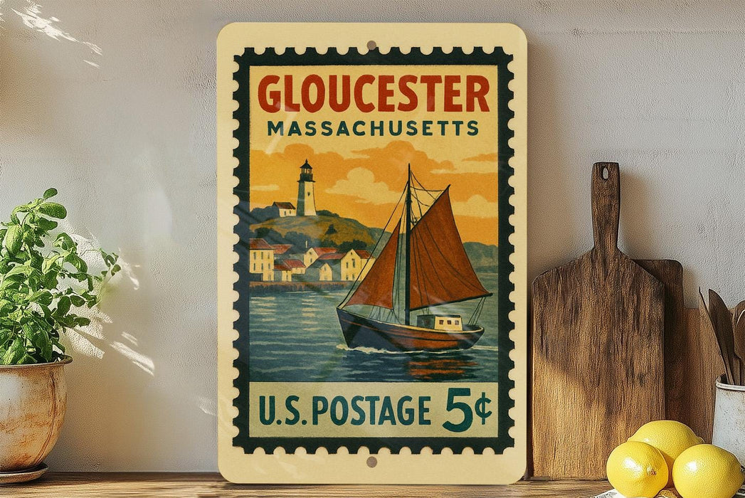 A vintage postage stamp from Gloucester, Massachusetts, featuring a sailboat on the water, is displayed on a shelf next to a wooden cutting board and some lemons.