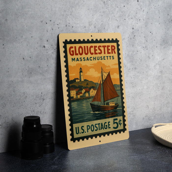 A vintage postage stamp from Gloucester, Massachusetts, featuring a sailboat on the water and a lighthouse in the background.