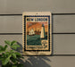 A vintage postage stamp from New London, Connecticut, featuring a lighthouse and a ship, is displayed on a wall.