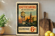 A vintage postage stamp from the United States, featuring an illustration of Hattiesburg, Mississippi, with a water tower and church in the background.