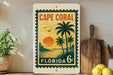 A vintage-style stamp depicting a tropical beach scene with palm trees, a sunset, and a body of water, along with the text "Cape Coral Florida 6c".