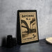 A Bayonne New Jersey postage stamp is displayed on a table, featuring an illustration of a bridge and steam pipes.