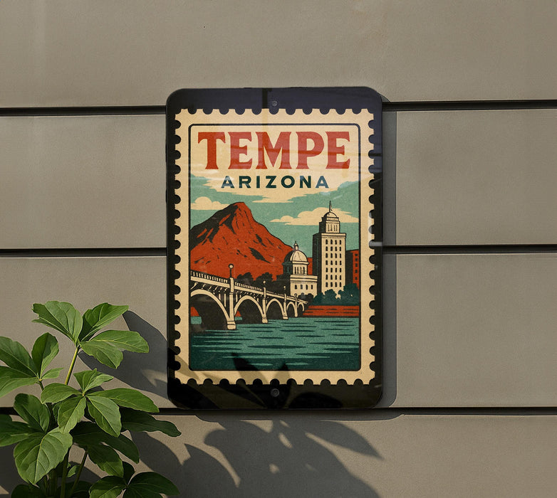 A vintage-style poster of Tempe, Arizona, featuring a mountain, bridge, and buildings, is displayed on a wall.
