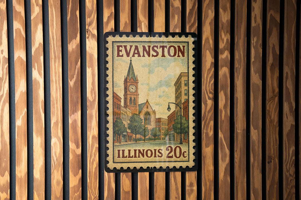 A vintage-style postage stamp from Evanston, Illinois, featuring a church and buildings, is displayed on a wooden wall.
