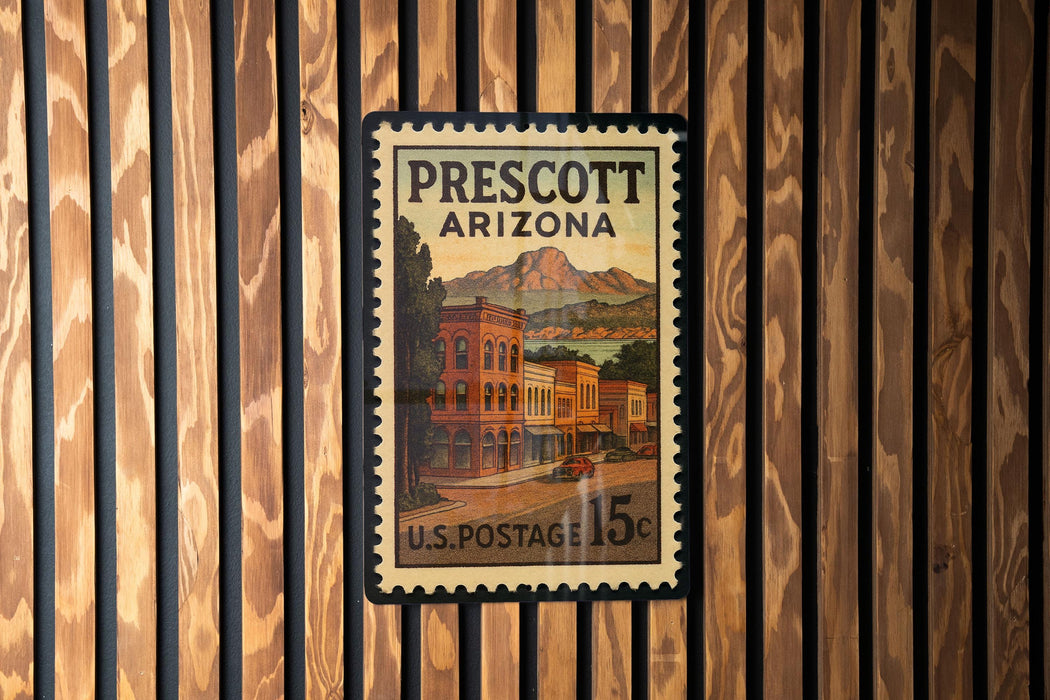 A vintage U.S. postage stamp from Prescott, Arizona, featuring a building and mountains in the background.