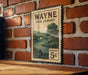 A vintage-style metal sign with a landscape illustration and the text "WAYNE NEW JERSEY" is displayed on a brick wall.