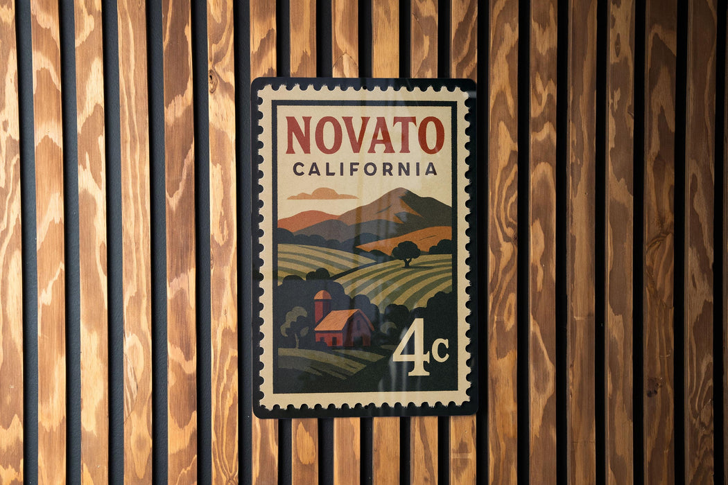 A vintage-style postage stamp from Novato, California, featuring a rural landscape with a farmhouse and mountains in the background.