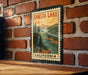 A vintage-style metal sign with the text "SHASTA LAKE CALIFORNIA" is displayed on a brick wall.