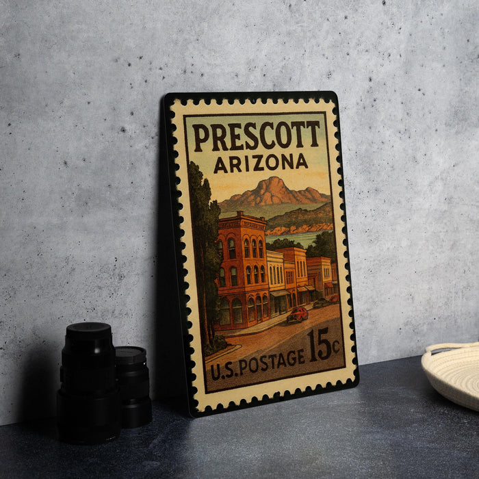 A vintage postage stamp from Prescott, Arizona, featuring a colorful illustration of buildings and mountains.