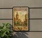 A vintage-style sign for Evanston, Illinois, featuring a clock tower and buildings, mounted on a wall.