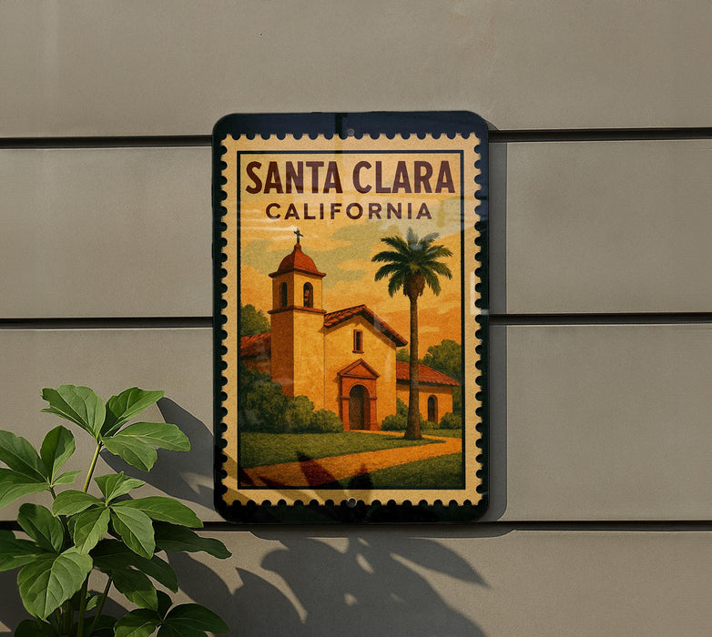 A framed poster of Santa Clara, California, featuring a church and palm trees, is displayed on a wall next to a plant.