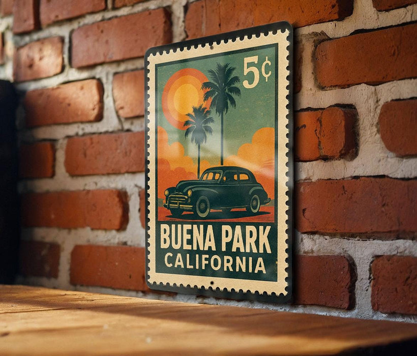 A vintage postage stamp featuring a car and palm trees, with the text "BUENA PARK CALIFORNIA" printed on it.