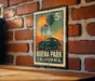 A vintage postage stamp featuring a car and palm trees, with the text "BUENA PARK CALIFORNIA" printed on it.