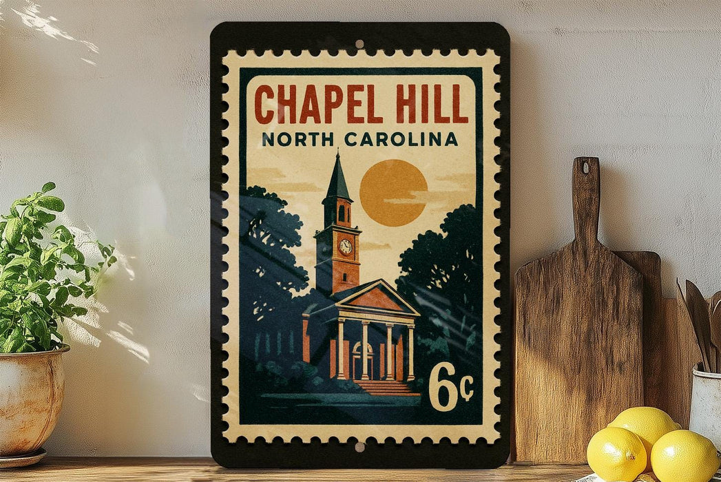 A vintage-style postage stamp depicting a church with a clock tower, surrounded by trees and a large sun, is displayed on a wall next to a wooden cutting board and some lemons.