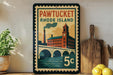 A vintage-style poster of Pawtucket, Rhode Island, featuring a building with a clock tower and a bridge over a river.