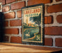 A vintage-style metal stamp depicting Lakeland, Florida, with a swan in the water and palm trees in the background.