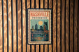 A vintage-style postage stamp from Nashville, Tennessee, featuring a cityscape with a bridge and a large sun in the sky.