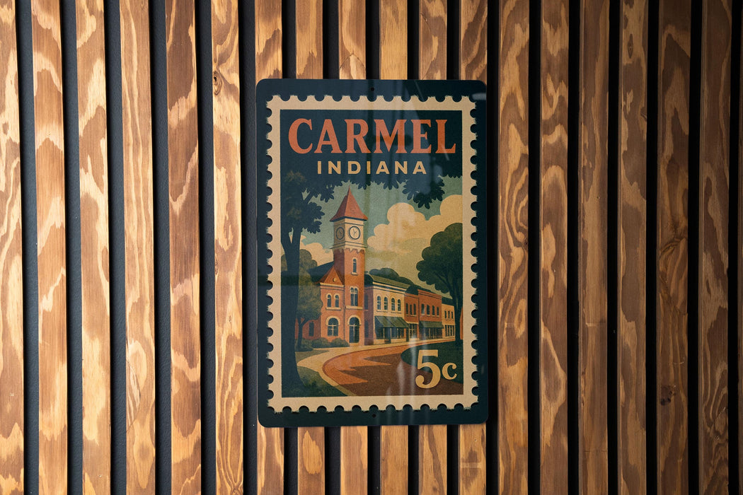 A vintage postage stamp from Carmel, Indiana, featuring a building with a clock tower.