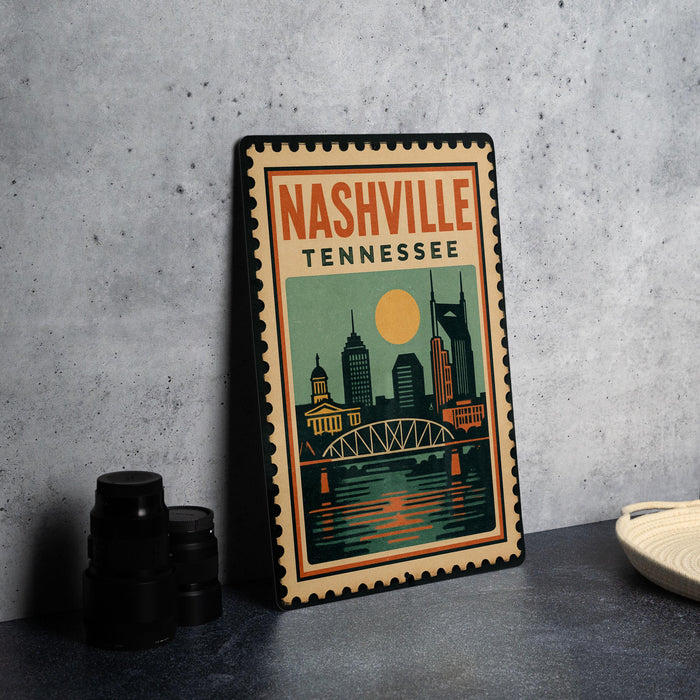 A vintage-style metal sign with the text "NASHVILLE TENNESSEE" and an illustration of the city skyline, including a bridge and a large yellow sun.