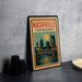 A vintage-style metal sign with the text "NASHVILLE TENNESSEE" and an illustration of the city skyline, including a bridge and a large yellow sun.