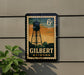 A vintage-style sign for Gilbert, Arizona, featuring a water tower silhouette and the text "6c" in the top right corner.