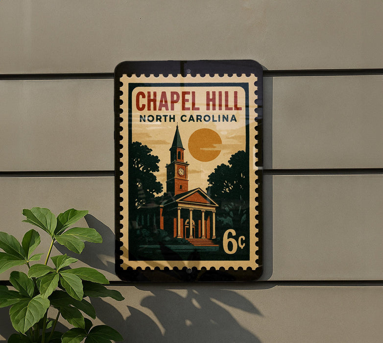 A vintage-style postage stamp depicting a church with a clock tower, mounted on a wall next to a plant.