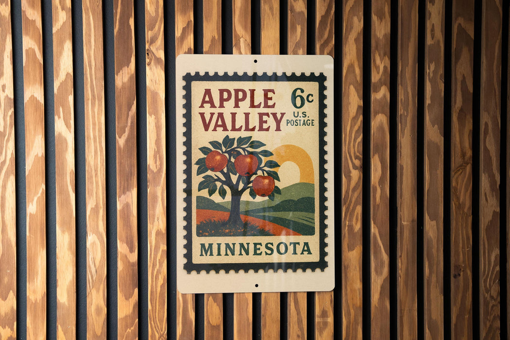 A vintage-style postage stamp from Minnesota, featuring an illustration of an apple tree with apples, mounted on a wooden wall.