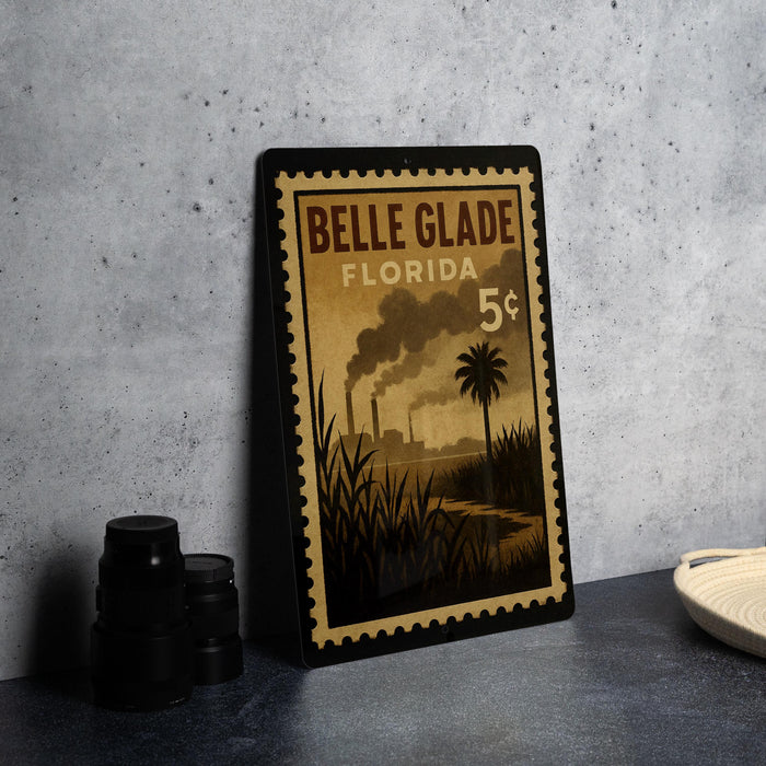 A vintage-style postage stamp from Belle Glade, Florida, featuring a palm tree and steam rising from a factory.
