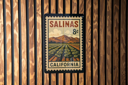 A framed vintage postage stamp from California, featuring a field of crops and mountains in the background.