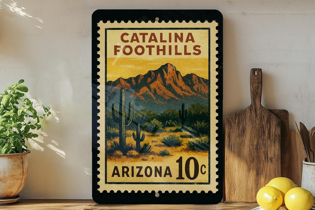 A framed poster of Catalina Foothills, a desert landscape with mountains in the background, is displayed on a wall next to a wooden cutting board and some potted plants.