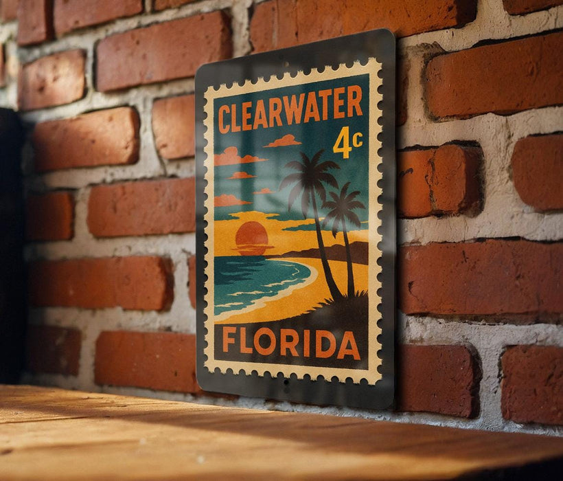 A metal sign with a tropical beach scene and palm trees, mounted on a brick wall.