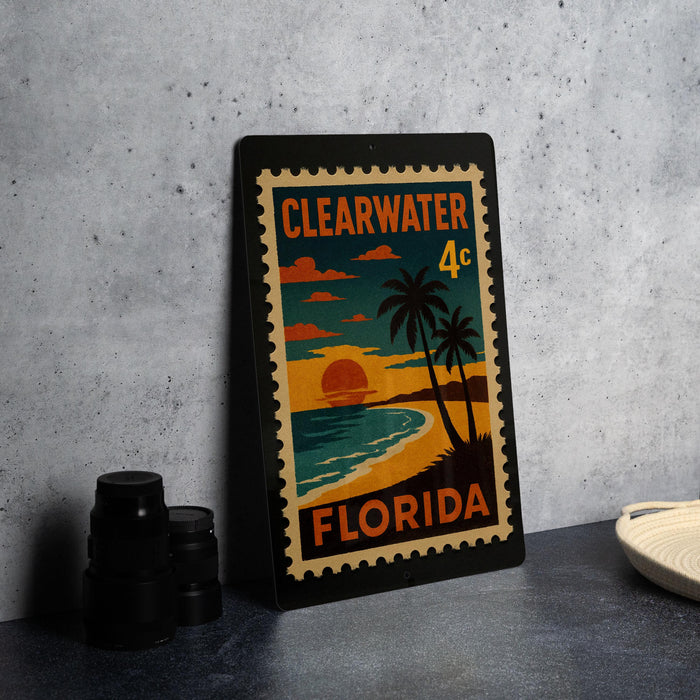 A framed poster of a beach scene with palm trees and a sunset, depicting Clearwater, Florida.