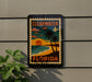 A sign that reads "CLEARWATER FLORIDA" is hanging on a wall, depicting a tropical beach scene with palm trees and a sunset.
