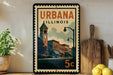 A vintage postage stamp from Illinois, featuring an illustration of a city street with buildings and a clock tower, is displayed on a shelf next to a wooden cutting board and some lemons.