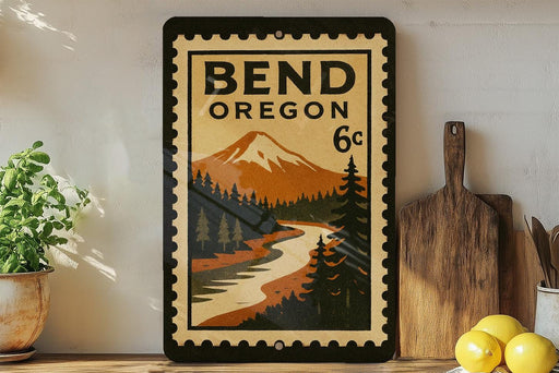 A vintage-style poster of Bend, Oregon, featuring a mountain landscape and a river, displayed on a wall next to a wooden cutting board and some lemons.